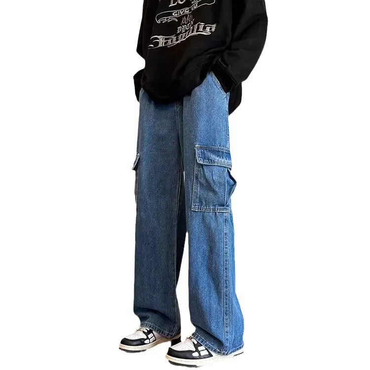 Person wearing wide-leg blue denim cargo jeans with large side pockets and black hoodie