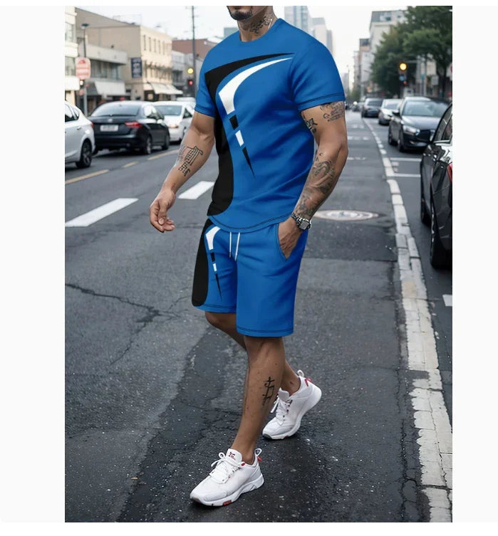 Man in blue athletic shorts and matching t-shirt with black and white abstract design walking on urban street wearing white sneakers