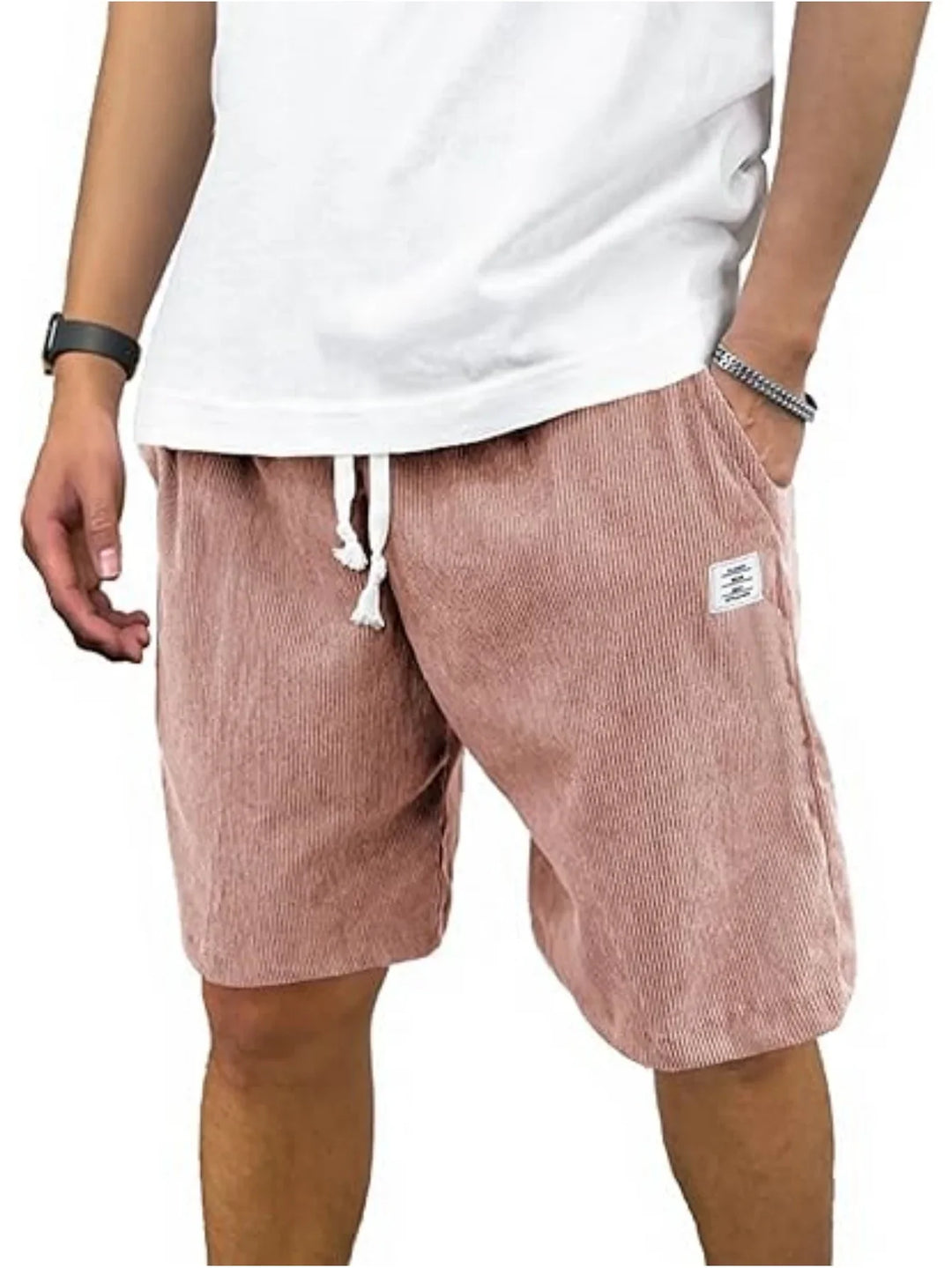 Man wearing pink corduroy shorts with white drawstring and a white t-shirt