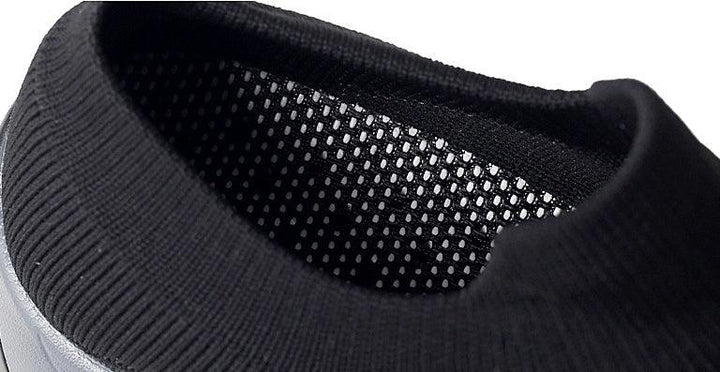 Close-up of black knit collar and mesh lining on casual sneaker