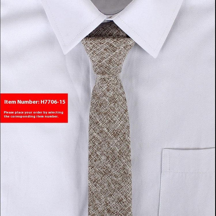 Close-up of textured brown and beige tie on white dress shirt with a pointed collar and pocket
