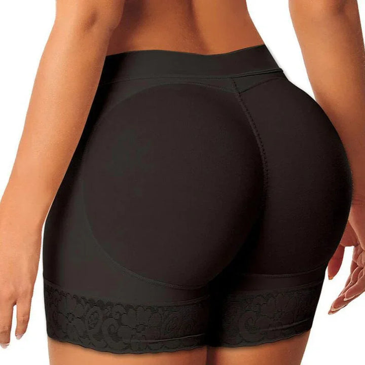 Close-up of a woman wearing black padded booty shaper shorts with lace trim on hips and thighs