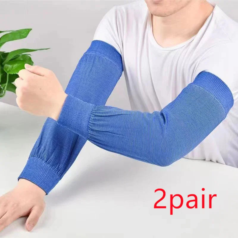 Person wearing blue striped arm sleeves on both arms sitting at white table with green plant