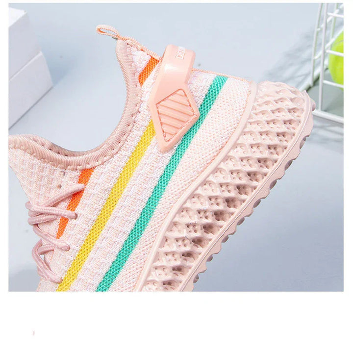 Pink knitted sneaker with orange, yellow, and green stripes and breathable textured sole