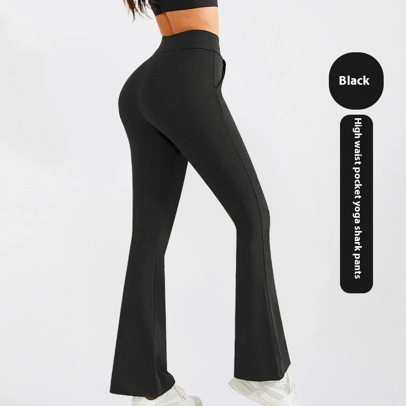 Woman wearing black high waist pocket yoga shark pants with flared legs and white sneakers