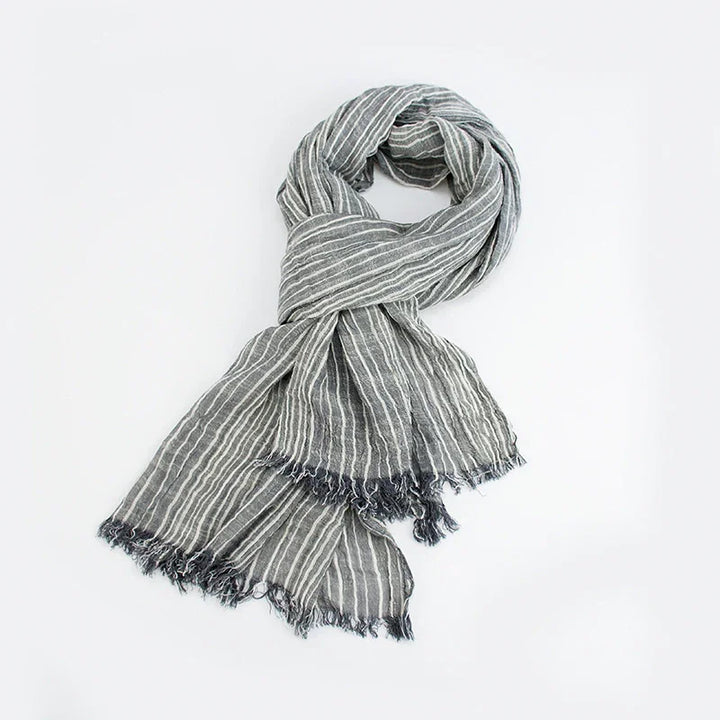 Gray and white striped lightweight scarf with fringed edges on a white background