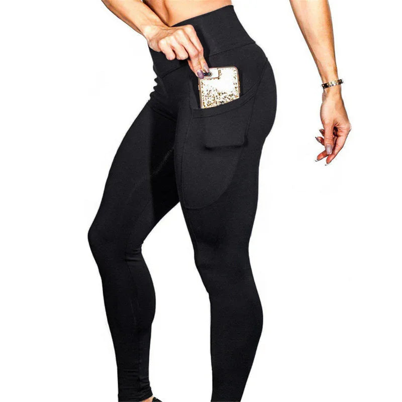 Woman wearing high-waist black leggings with side pocket holding a gold glitter phone