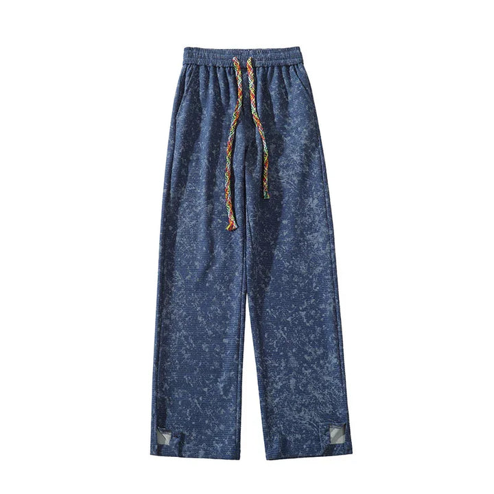Blue textured sweatpants with multicolor braided drawstring and reflective patches near hems