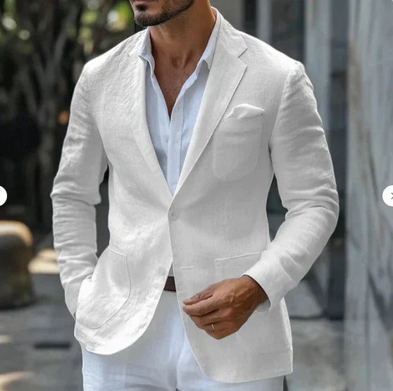 Man wearing a stylish white linen blazer with matching pants and an open-collar shirt outdoors