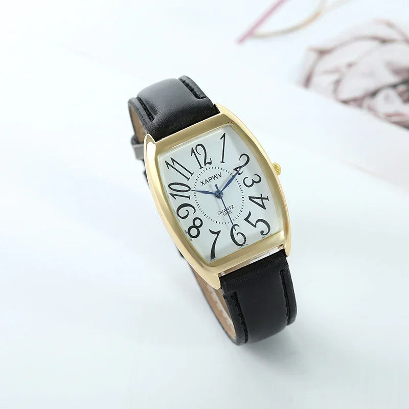 Gold-tone rectangular wristwatch with black leather strap and white dial featuring large, stylized black numbers