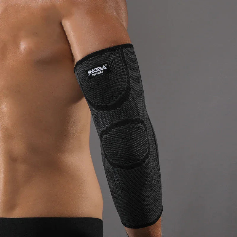 Black compression elbow sleeve on bare arm for joint support and pain relief