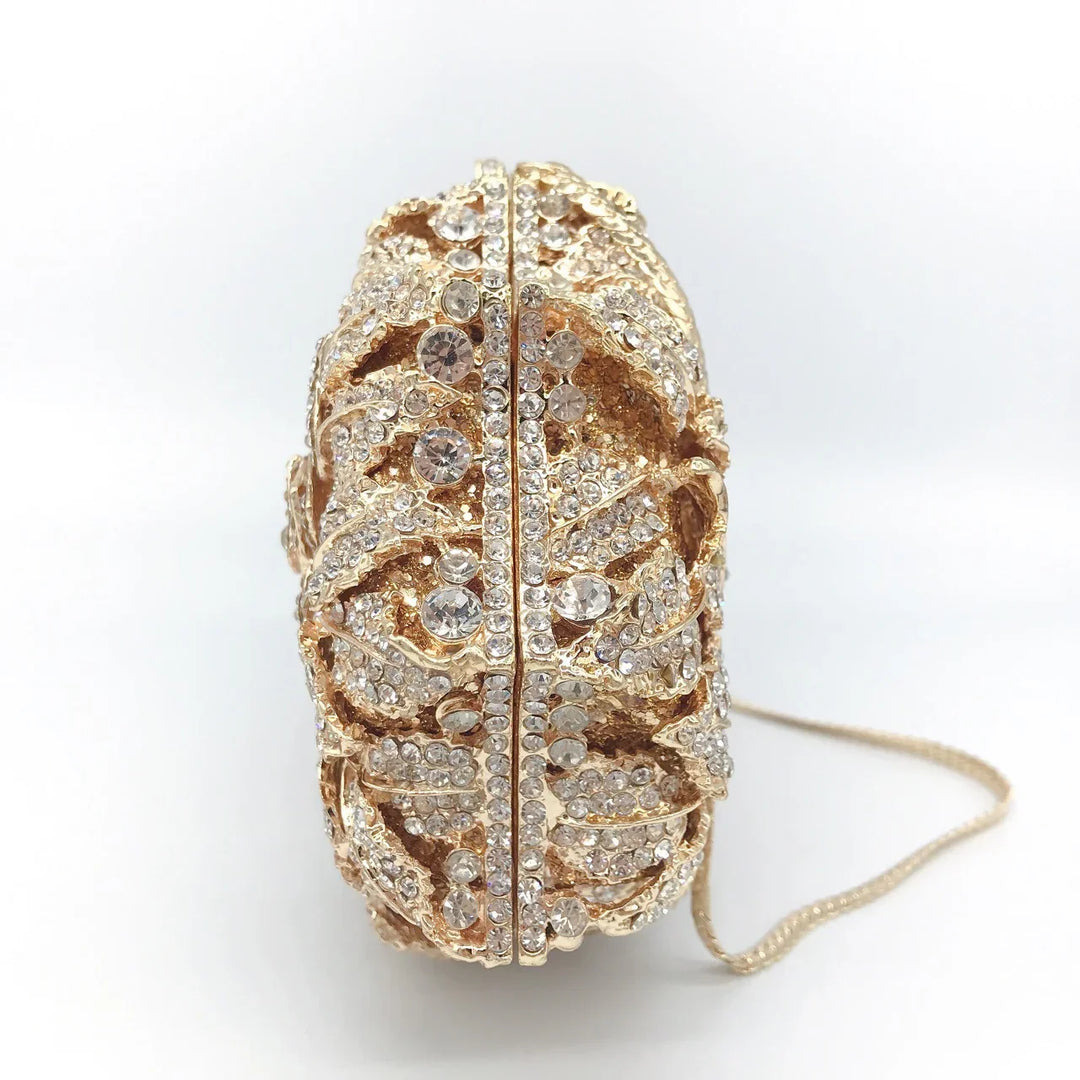 Gold-tone evening clutch bag adorned with intricate crystal rhinestone embellishments and chain strap