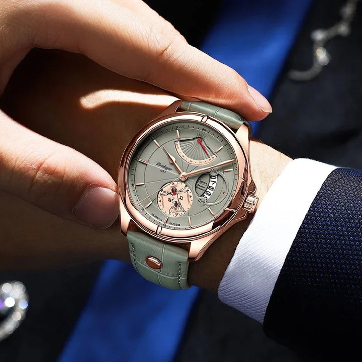 luxury men's wristwatch with rose gold case and grey leather strap on wrist in formal attire