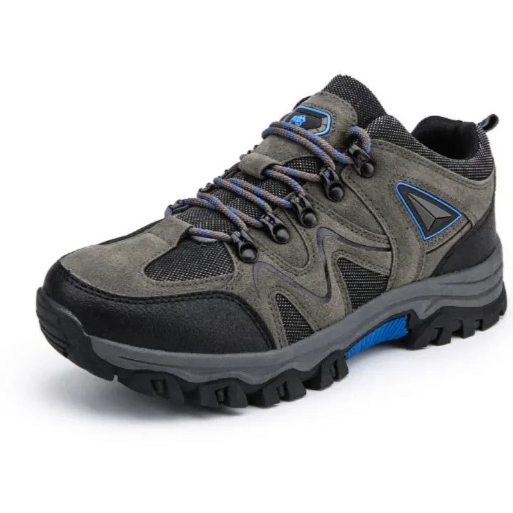 Gray and black hiking shoe with blue accents and rugged sole on white background