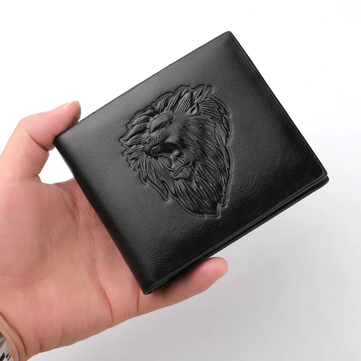 Hand holding black leather wallet with embossed roaring lion head design