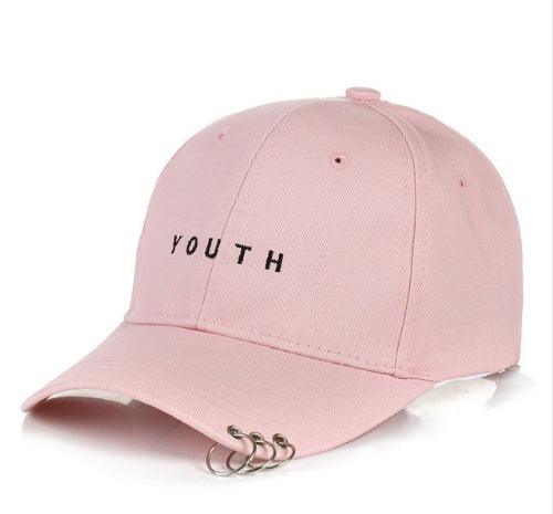 Pink baseball cap with black YOUTH text and three silver metal rings on the brim