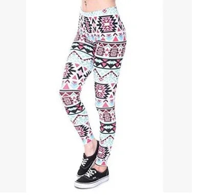Woman wearing high-waisted leggings with colorful Aztec geometric print and black sneakers