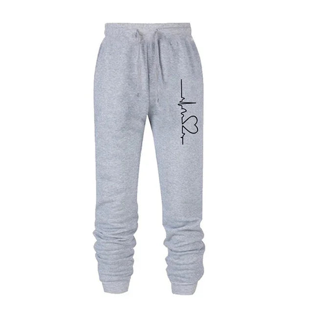 Gray sweatpants with drawstring waist and black heartbeat and heart graphic on left thigh