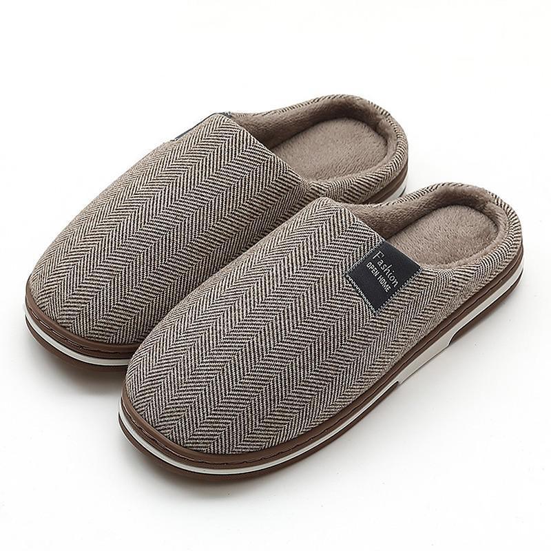 Pair of brown herringbone indoor slippers with soft plush lining and rubber sole on white background
