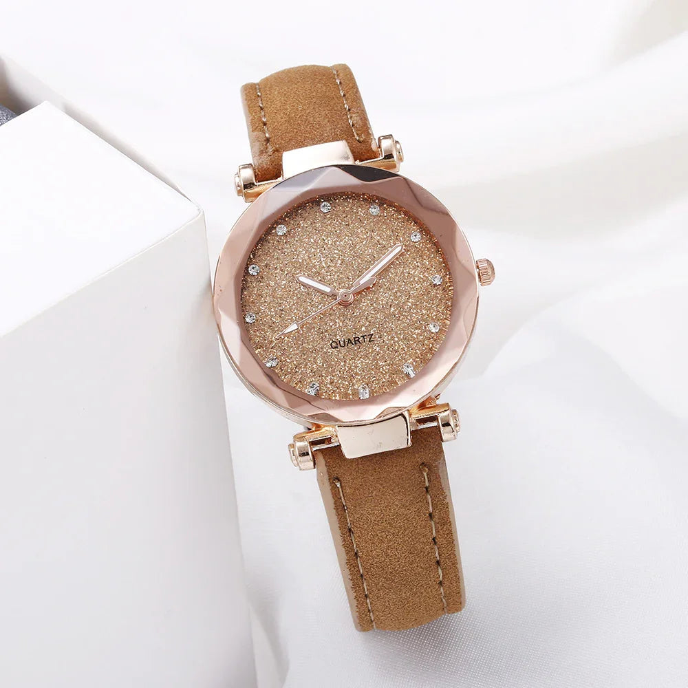 Elegant women's quartz watch with glittery gold dial and brown suede strap