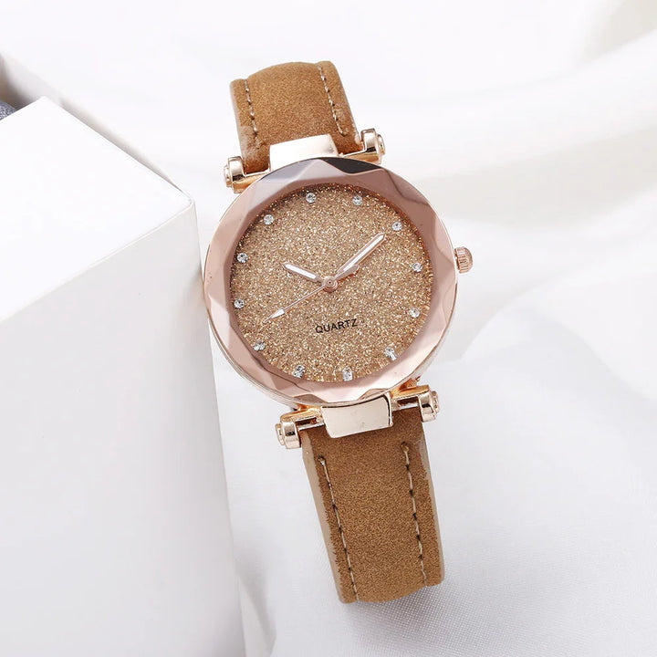 Elegant women's quartz watch with glittery gold dial and brown suede strap