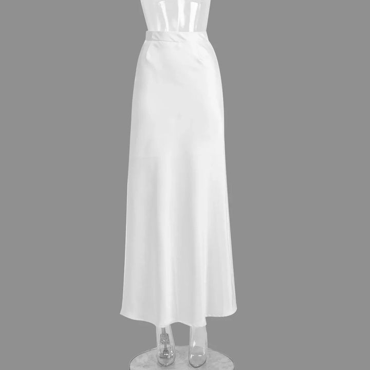 White satin long skirt on transparent mannequin against gray background