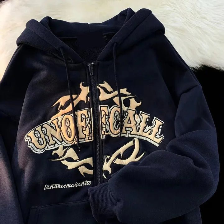 Black zip-up hoodie with beige tribal flame design and 'UNOFFICIAL' text on chest