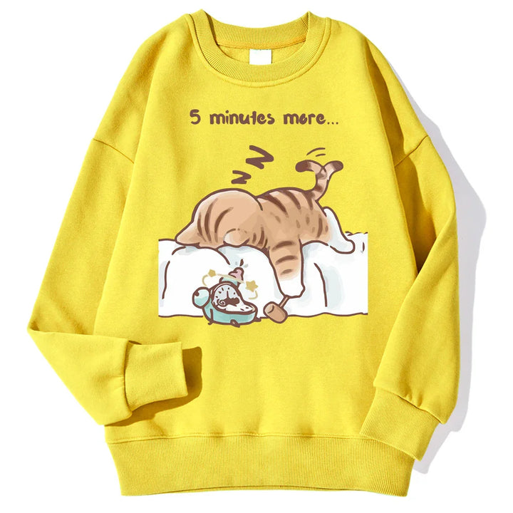 Yellow sweatshirt with cartoon cat sleeping on bed and alarm clock, text '5 minutes more'