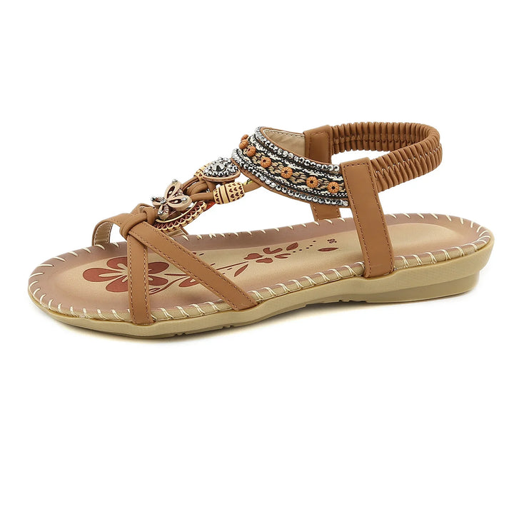 Brown women's flat sandal with beaded and floral ankle strap decoration and floral insole design