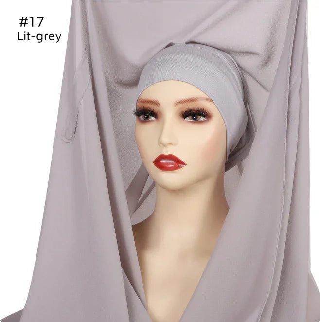 mannequin head wearing light grey hijab cap and matching fabric with red lipstick