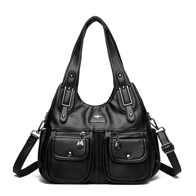 Black leather handbag with dual top handles, adjustable shoulder strap, front zip and button pockets, and silver logo