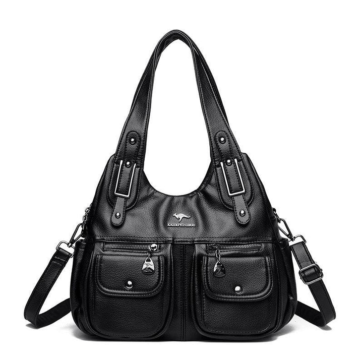 Black leather handbag with dual top handles, adjustable shoulder strap, front zip and button pockets, and silver logo