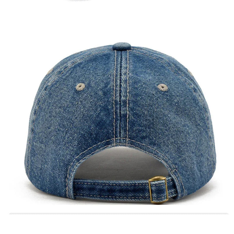 Back view of blue denim baseball cap with adjustable strap and metal buckle on white background