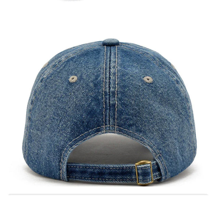 Back view of blue denim baseball cap with adjustable strap and metal buckle on white background