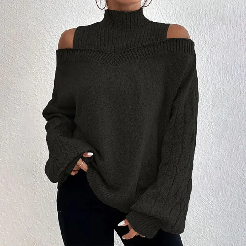 Woman wearing black cold shoulder turtleneck knit sweater with cable knit sleeves