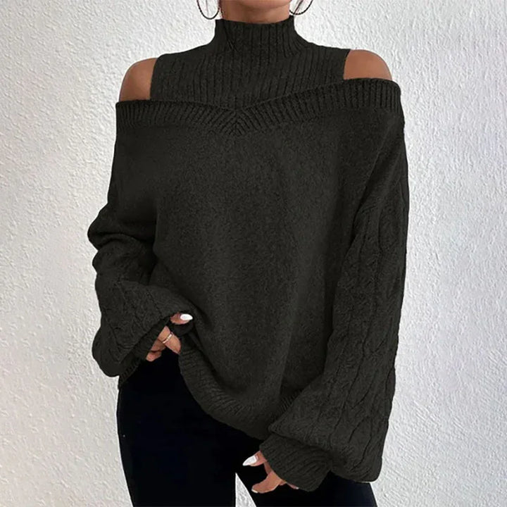 Woman wearing black cold shoulder turtleneck knit sweater with cable knit sleeves