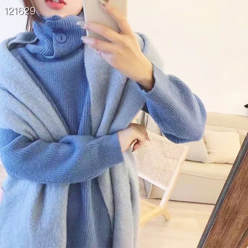 Person wearing cozy blue knit sweater and light gray wool shawl taking mirror selfie in bright room