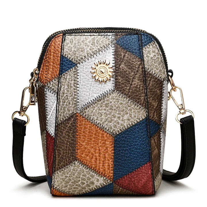 Small leather crossbody bag with colorful geometric patchwork and sun emblem detail