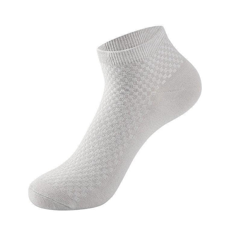 White ankle sock with textured knit pattern and ribbed cuff on white background