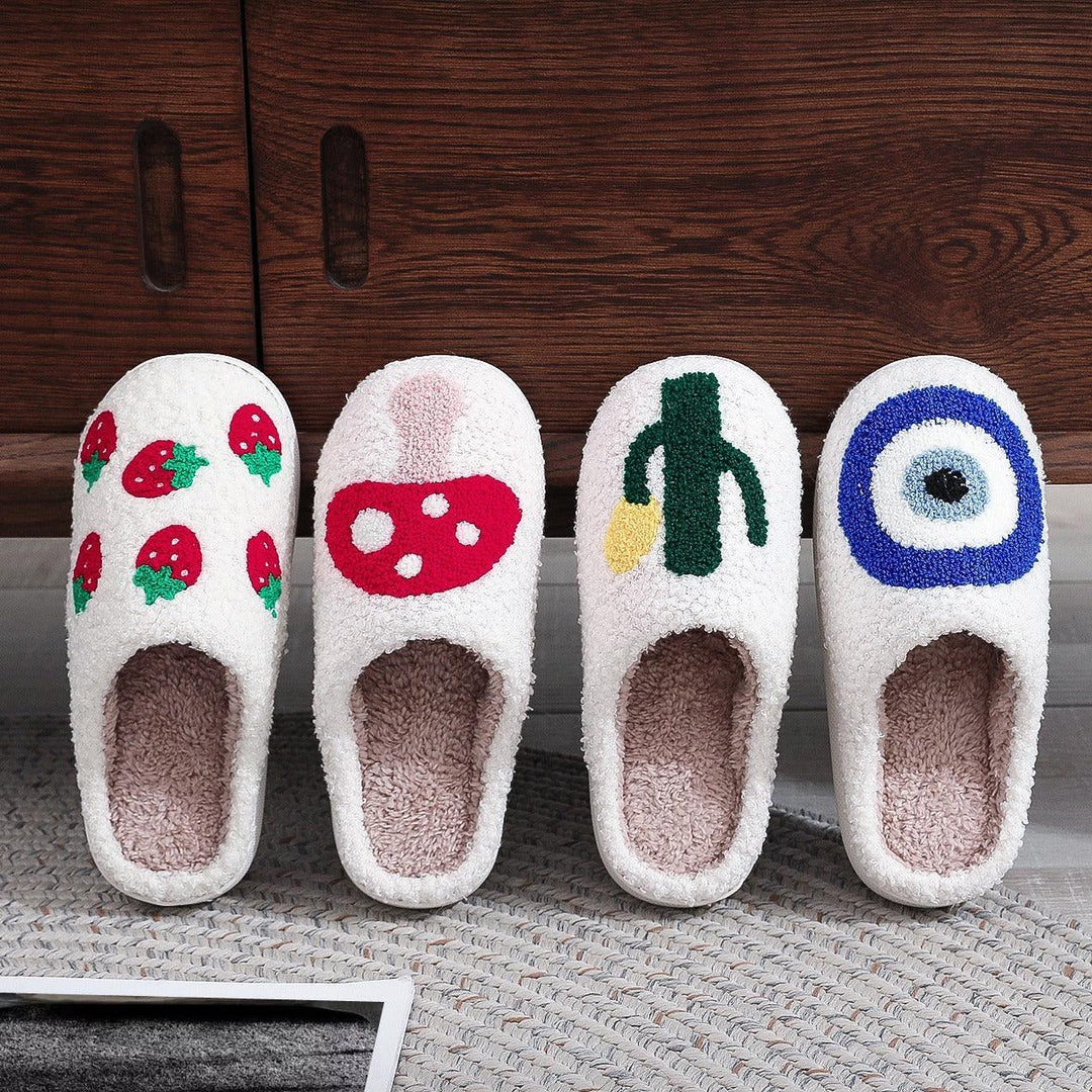 Set of four cozy white slippers with embroidered strawberry, mushroom, cactus, and blue circle designs