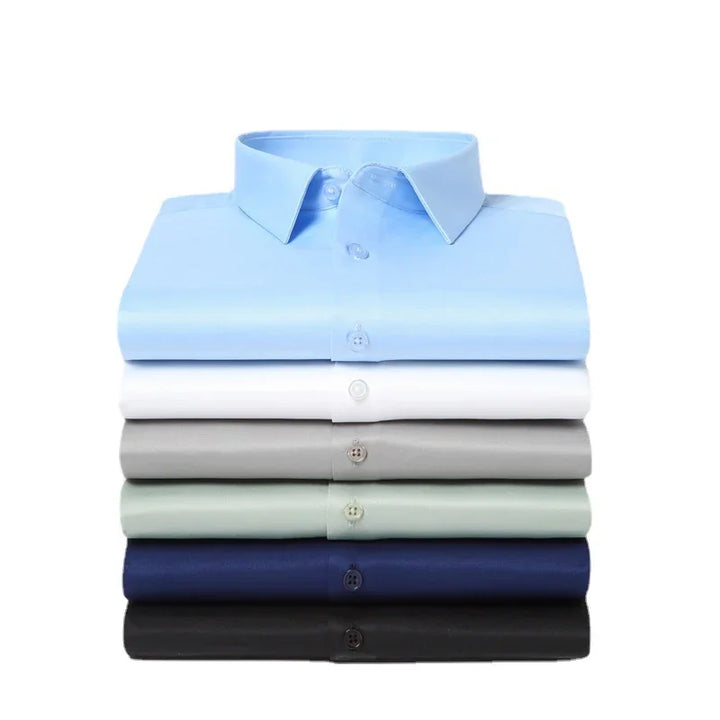 Stack of six neatly folded dress shirts in blue, white, gray, green, navy, and black colors