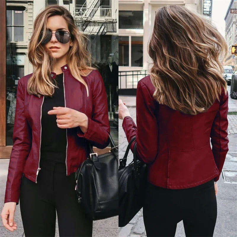 Stylish woman wearing a red leather jacket and black pants holding a black handbag in an urban street setting