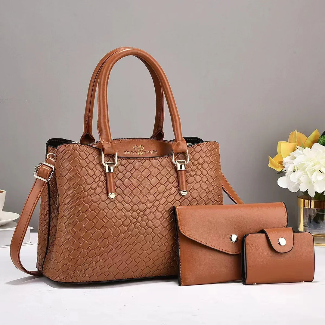 Brown woven leather handbag with matching wallet and coin purse on white surface