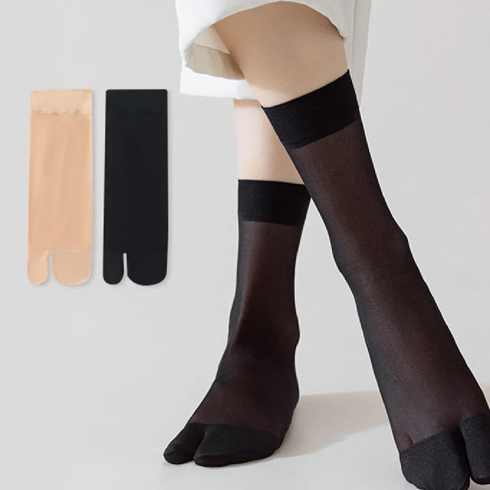 Woman wearing black sheer tabi socks with toe separation, nude and black sock pairs displayed