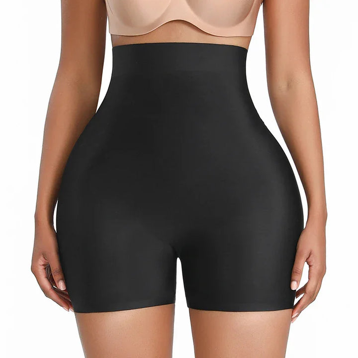 Woman wearing black high-waisted shapewear shorts designed for body contouring and waist slimming