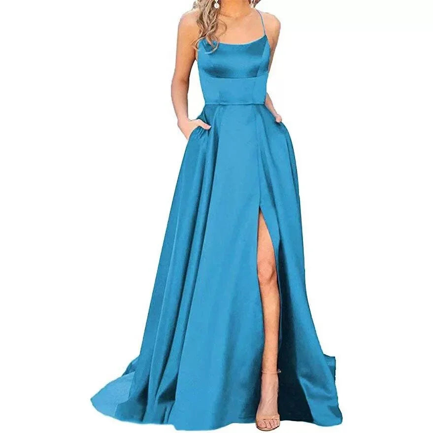Woman wearing elegant blue satin evening gown with spaghetti straps and thigh-high slit