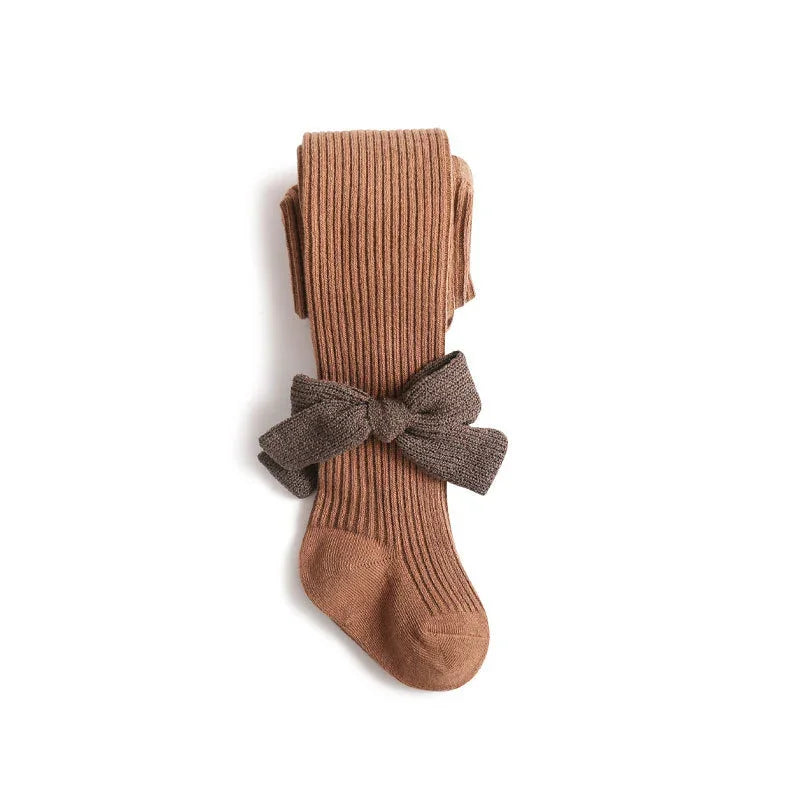 Brown ribbed knit tights with a dark brown fabric bow on a white background