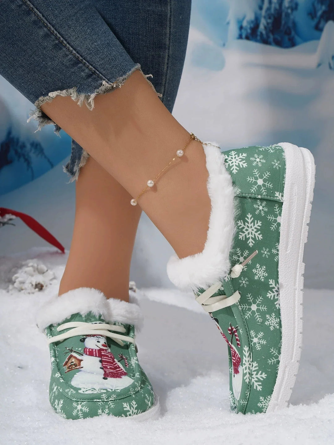 Winter slippers with snowman and snowflake pattern, white fur lining, worn with frayed denim jeans