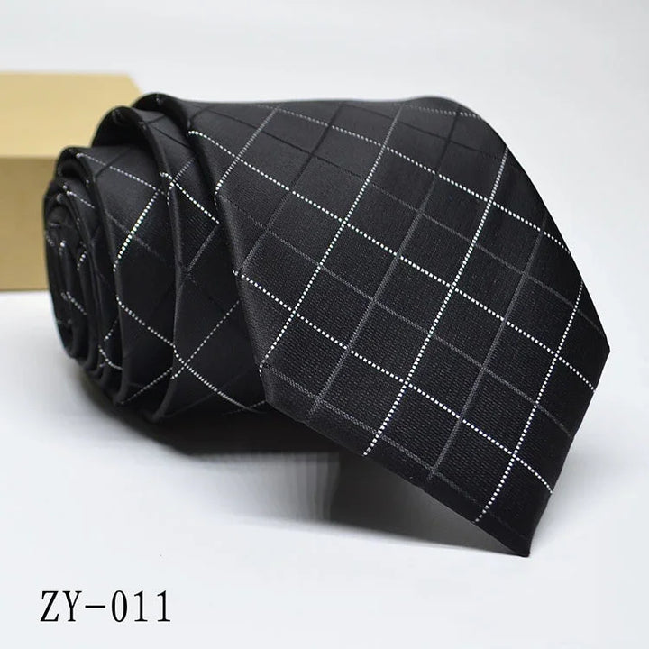 Black necktie with white grid pattern rolled on white surface, product code ZY-011