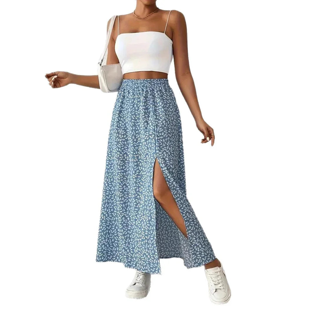 Woman wearing a white crop top and blue floral high-slit maxi skirt with white sneakers